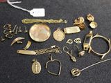 a lot of gold jewelry on a black surface