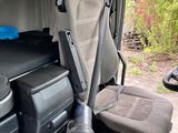 an image of a vehicle with a seat and a cooler