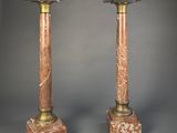 pair of marble and brass pedestals on a grey background