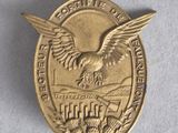 une image représentant une médaille d'or sur laquelle figure un aigle
