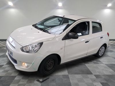 a picture of a small white car parked in a garage