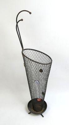 an umbrella stand with a metal umbrella holder on top of it