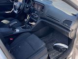 the interior of a car with the door open and the driver ' s seat down