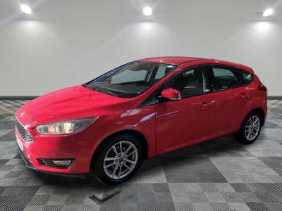 a red ford focus is parked on a checkered floor