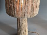 a lamp that is made out of wood on a table