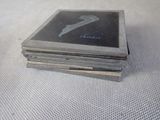 a stack of four coasters sitting on top of a table