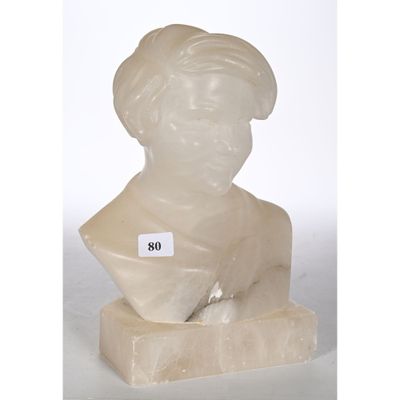 a white marble bust of a woman with a hat on top of it