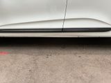 a picture of a white car parked on the side of the road