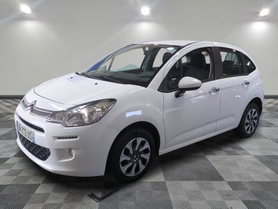 the white citrole is parked on a checkered tile floor
