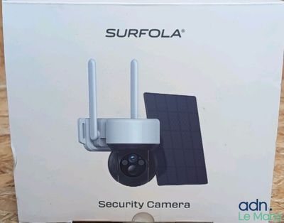 the box of the camera is open on the wooden floor