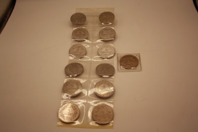 a cross made out of coins on a table