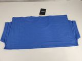 a close up of a blue shirt on a white table
