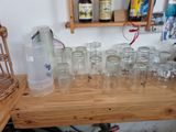bottles and glasses on a wooden table with a bottle of water