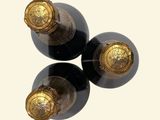 three bottles of wine that are sitting on a table