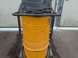 a large yellow drum with a black lid on a cart