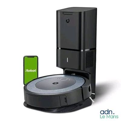 an image of a robotic vacuum cleaner with a phone next to it
