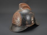 an old fireman ' s helmet on a black background