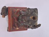 a small statue of a man on a red box