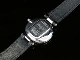 a close up of a wrist watch on a black surface
