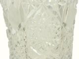 a close up of a glass vase on a white surface