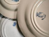 three plates with blue designs on them stacked on top of each other