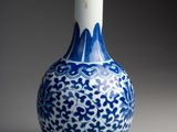 a blue and white vase that is sitting on a table