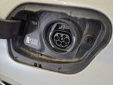 a close up of a car ' s fuel tank with a plugged in