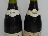 two bottles of wine sitting next to each other on a table