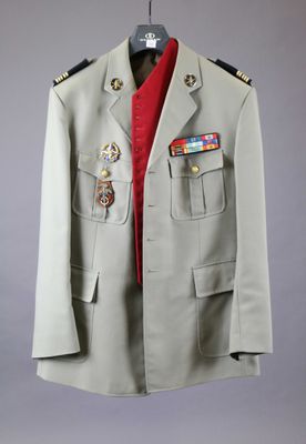an image of a military jacket hanging on a hanger