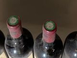 several bottles of wine are lined up in a row on a table