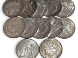 a close up of a bunch of coins on a white surface