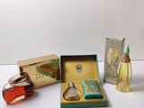 three different perfumes in a box on a table