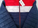 a red, white and blue jacket with a tag on it
