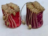 pair of red and gold candle holders on a white background
