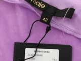 a close up of a purple shirt with a tag on it