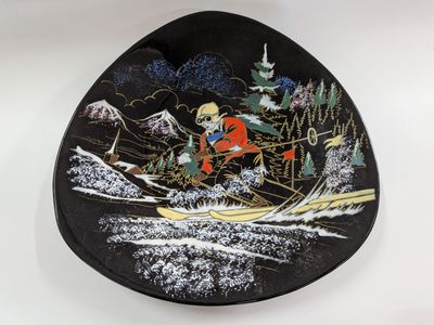 an image of a black plate with a picture of a man on skis