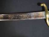 a close up of a sword on a black surface