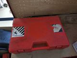 a red tool box sitting on top of a table