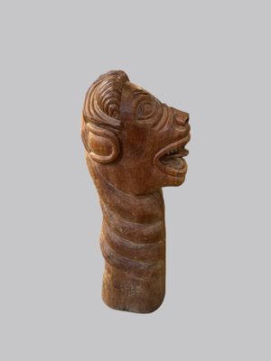 a close up of a sculpture of a head on a gray background