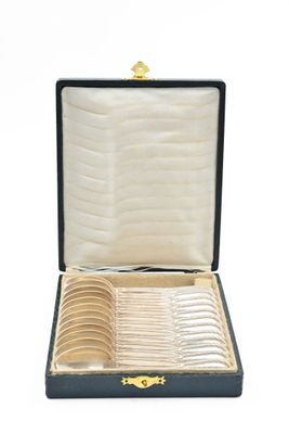a black case with a bunch of silver spoons in it