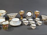 many different types of coffee cups and saucers on the table