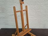 a wooden easel with a ball on top of it
