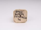 a close up of a piece of pottery with writing on it