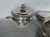 a silver plate with a lid and a silver bowl with a lid