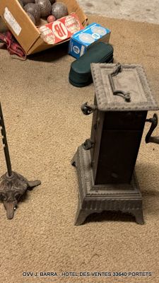 a cat that is laying on the floor next to a stove