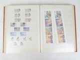 an open book with stamps on it on a table
