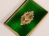 an image of a green book with a gold emblem on it