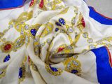 a close up of a white and blue scarf with a red and blue border