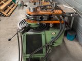 a machine that is sitting in a garage with a lot of tools