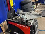 a machine that is sitting in a garage with a tire on it
